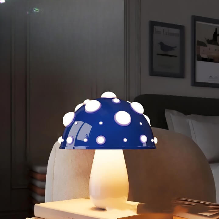 Blue and white polka dot mushroom-shaped table lamp with a glowing base.