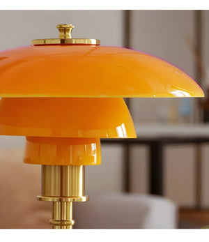 Bright orange and gold retro-style table lamp with a tiered shade design.