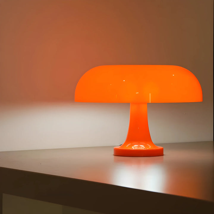 Bright orange mushroom-shaped table lamp with a glossy finish.