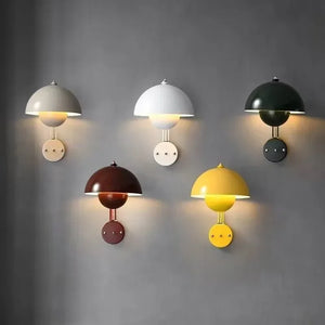 Collection of colorful dome-shaped wall sconces in various hues.