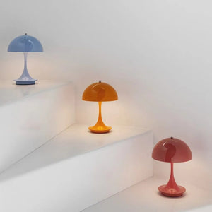 Colorful retro-style table lamps with dome-shaped shades on slender stems.