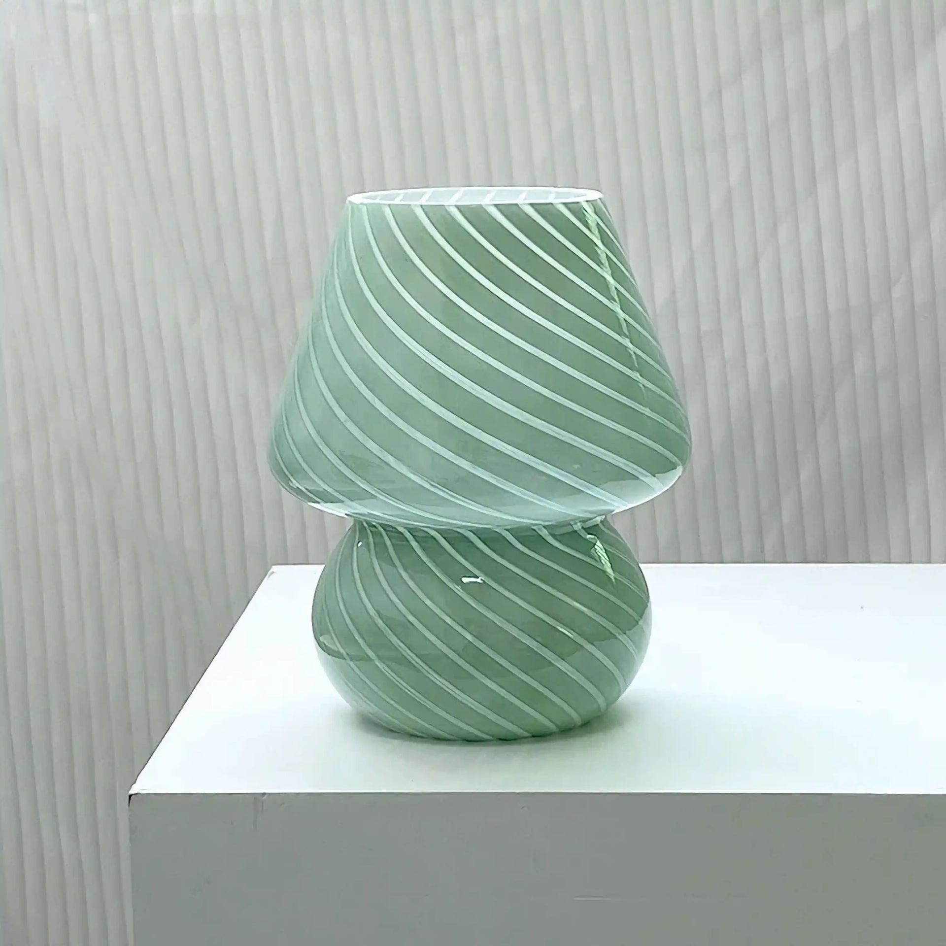 Mint green glass mushroom-shaped lamp with diagonal swirl pattern.