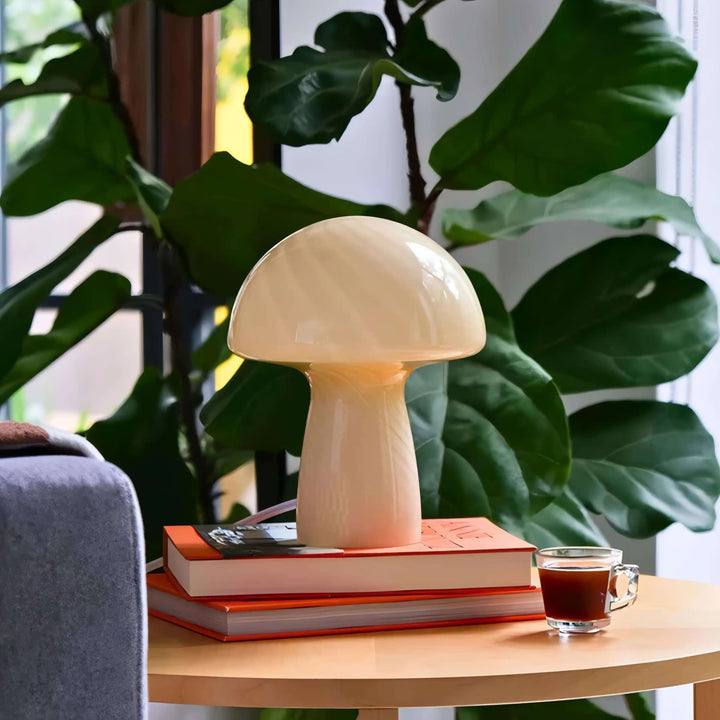 Mushroom-shaped lamp sitting on books.