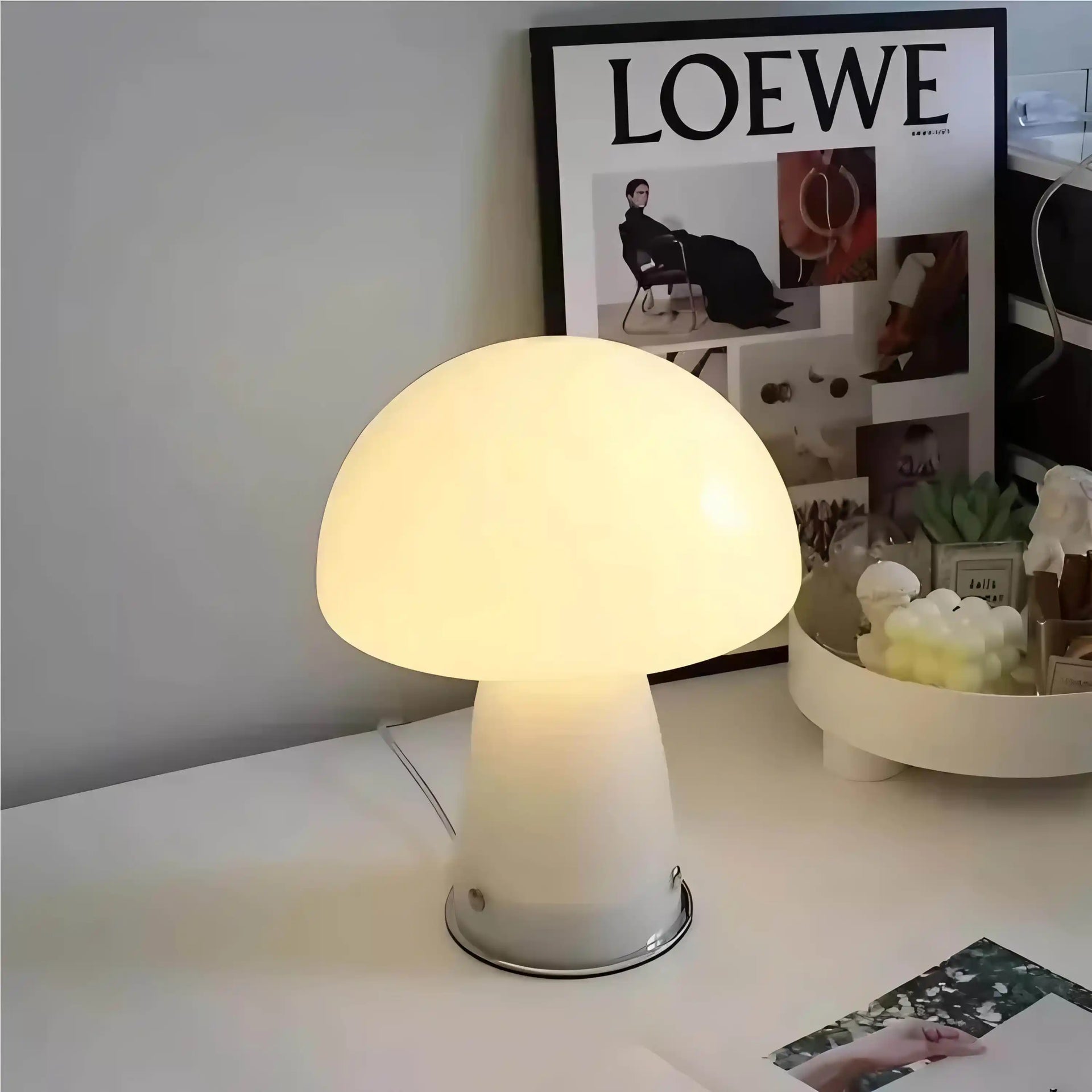 Glowing mushroom-shaped table lamp with a white base and rounded cap.