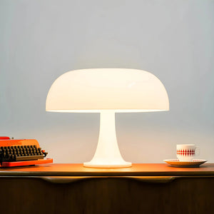 Mushroom-shaped table lamp with a white dome shade and stem.