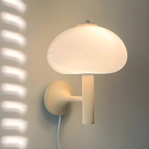 Mushroom-shaped wall lamp with a white dome shade.