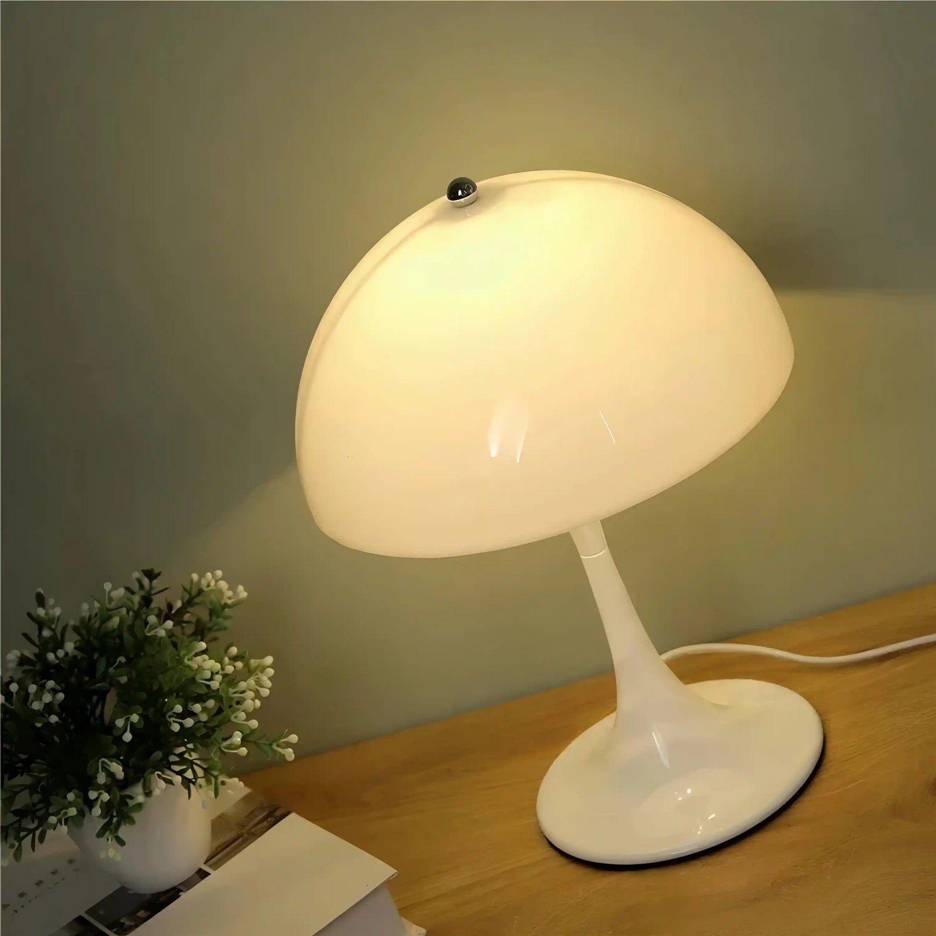 Retro-style white mushroom-shaped table lamp with a curved shade.