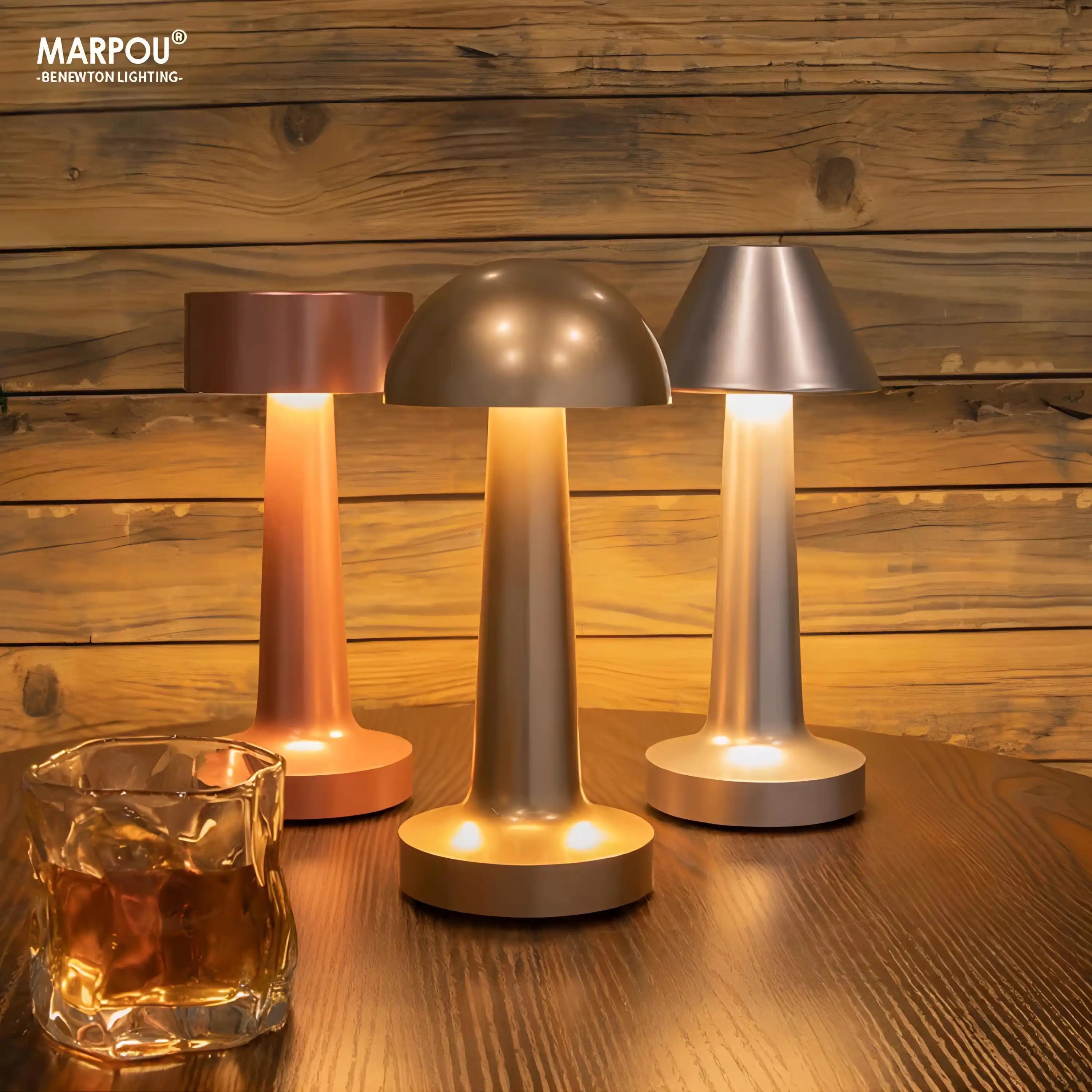 Set of three modern, cordless table lamps with mushroom-shaped designs in different metallic finishes.