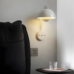 Wall-mounted dome lamp with a white shade and circular base.