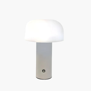 Modern table lamp with a cylindrical base and rounded white shade.