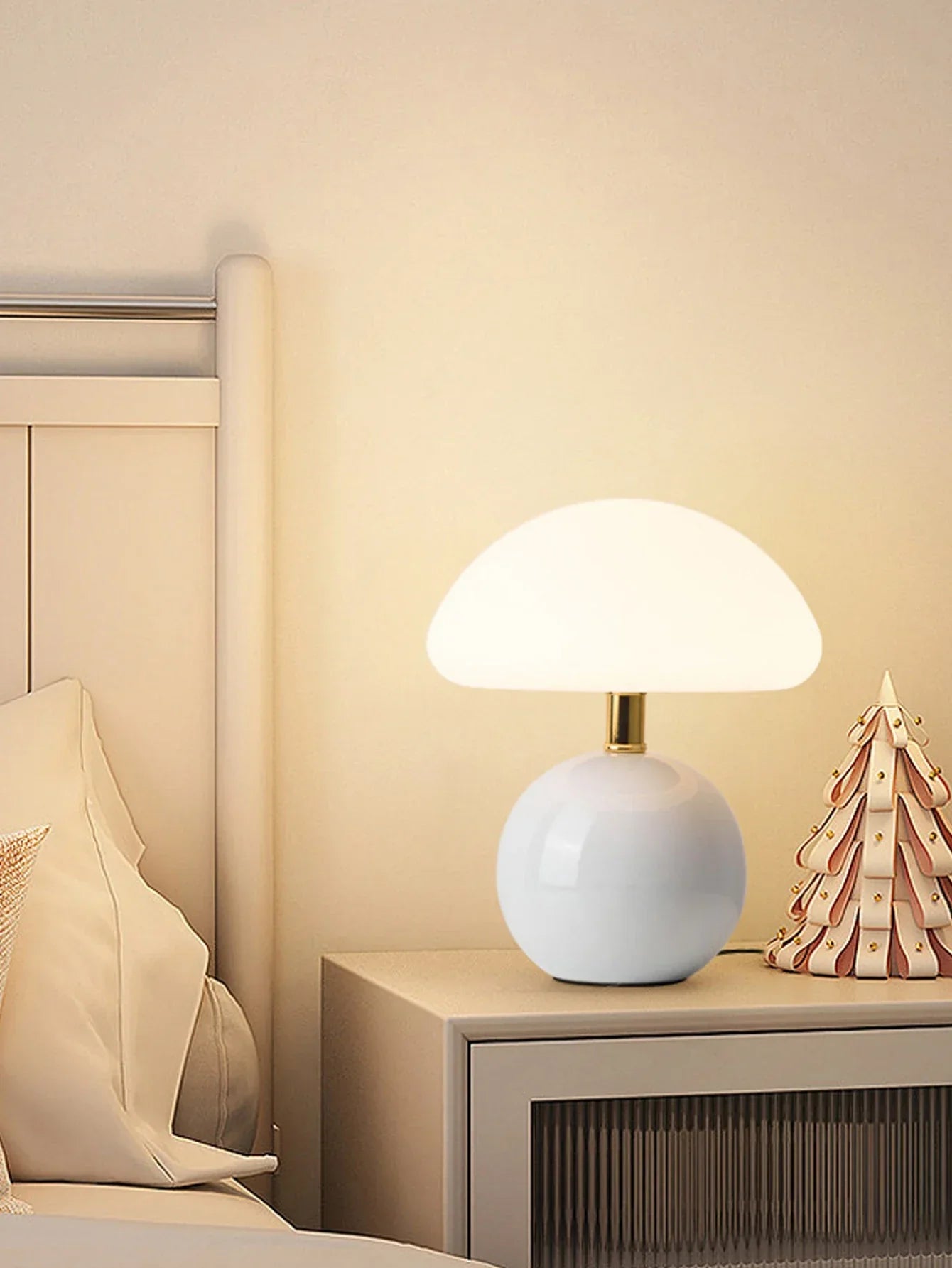 Glowing white mushroom-shaped table lamp with a spherical base.