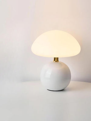 Mushroom-shaped table lamp with a white spherical base and domed shade.