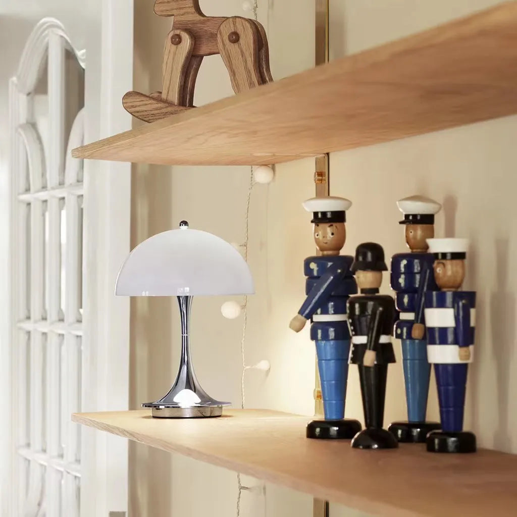 Wooden shelves displaying decorative figurines and a small table lamp.