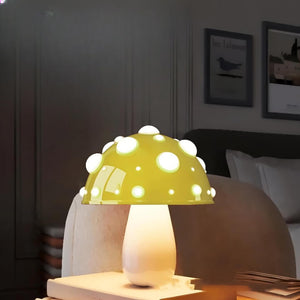 Whimsical mushroom-shaped table lamp with a yellow polka-dotted cap.